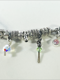 DevaArt Studio: eclectic handmade bracelet: sterling, antique silver, vintage beads, silver charms, Swarovski crystals.