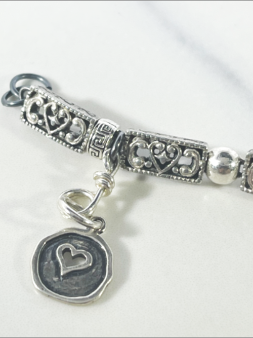 DevaArt Studio: eclectic handmade bracelet: sterling, antique silver, vintage beads, silver charms, Swarovski crystals.